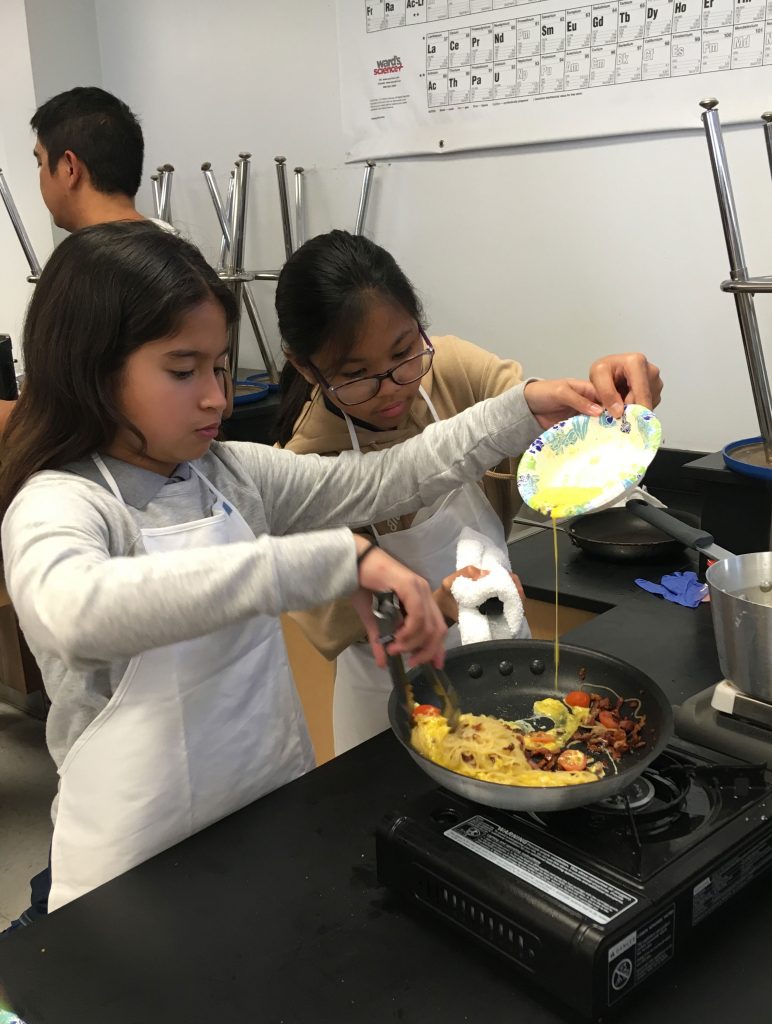 Cook Club students stir the egg